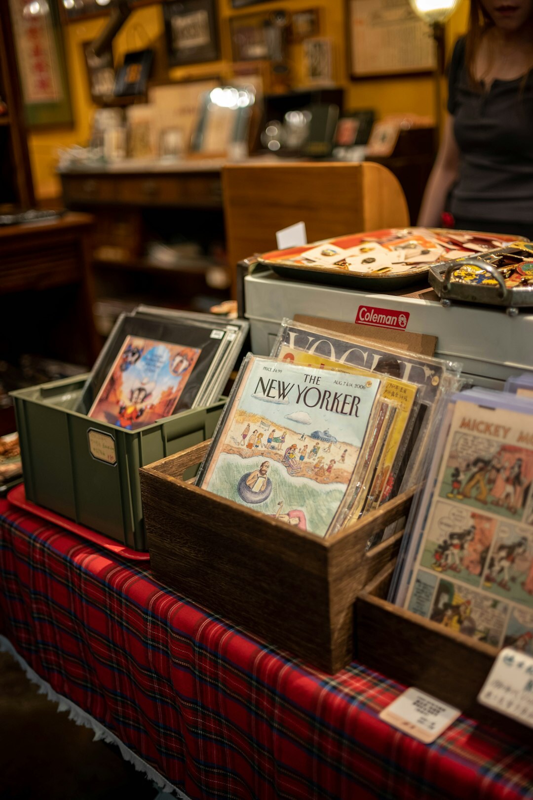 Stack of vintage advertising posters and magazines on a table